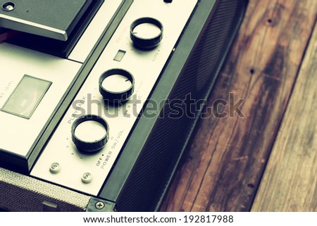 close up of old reel to reel recording machine. filtered image
