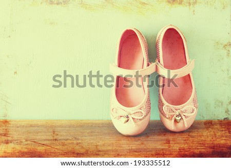 girl shoes over wooden deck floor. filtered image