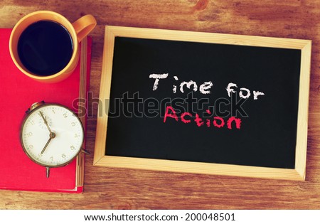 clock, coffee cup and blackboard with the phrase time for change
