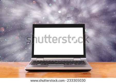 laptop over wooden table with empty screen ready for mock up and blurry bokeh background