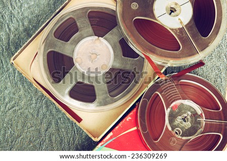 top view of old sound recording tape, reel to reel type and box.