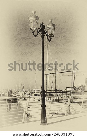 antique street lamp with yacht with black and white style texture overlaid effect