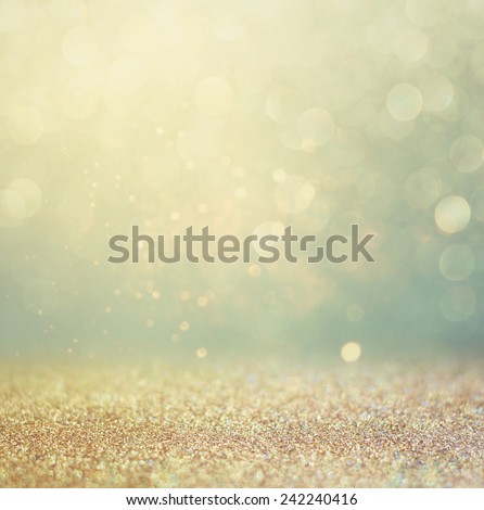 glitter vintage lights background. gold, silver, blue and black. de-focused.