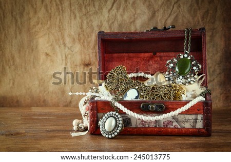 A collection of vintage jewelry in antique wooden jewelry box