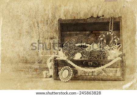 A collection of vintage jewelry in antique wooden jewelry box.  retro filtered image. Old style photo.