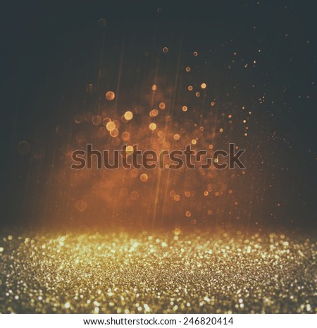 glitter vintage lights background. light gold and black. defocused.