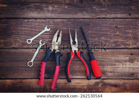 top view of assorted work tools over wooden background