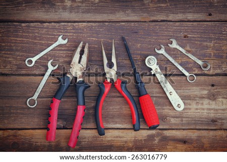 top view of assorted work tools over wooden background