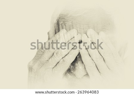 Double exposure portrait of senior man covering his face with his hands. black and white image, vintage effect