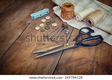 Vintage Background with sewing tools and sewing kit over wooden textured background