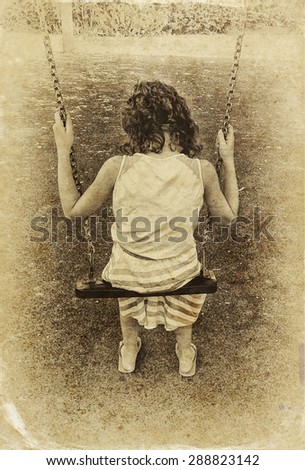 cute little girl playing in the garden Swinging on a swing. filtered image, old style photo