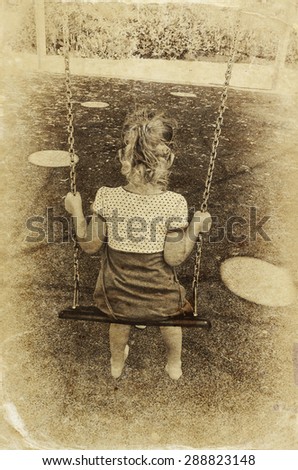 cute little girl playing in the garden Swinging on a swing. filtered image, old style photo