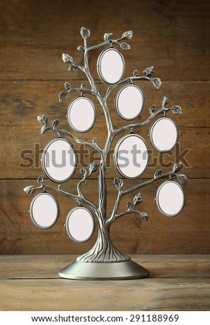 Image of vintage antique classical frame of family tree on wooden table. 9 frames