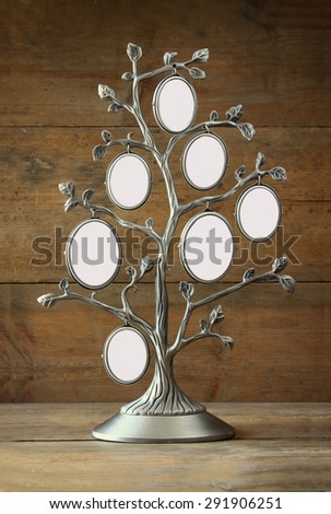Image of vintage antique classical frame of family tree on wooden table. 7 frames