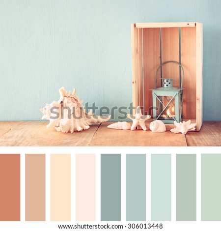 sea shells and lantern on wooden table. vintage filtered image. nautical lifestyle concept. with palette color swatches