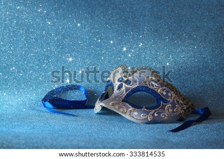 blue female carnival mask and glitter background. with glitter overlay