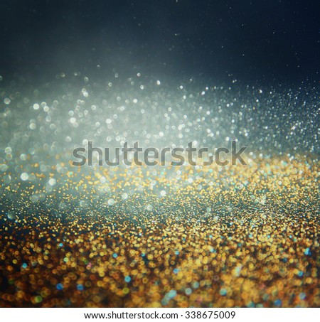 glitter vintage lights background. light , blue, gold and black. defocused.