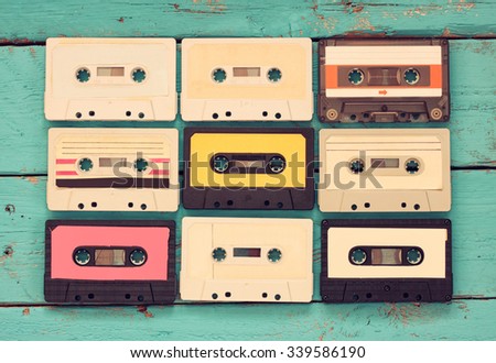 Cassette tapes over blue textured wooden table . top view. retro filter