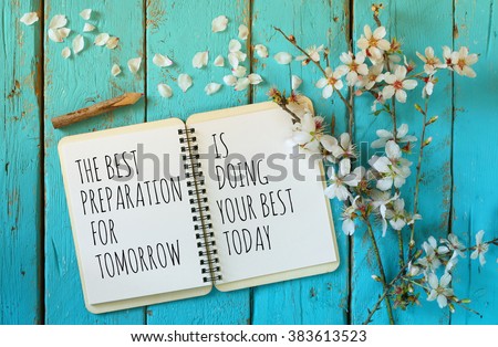 open notebook over wooden table with motivational saying the best preparation for tomorrow is doing your best today
