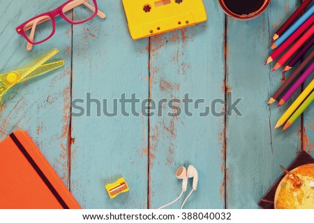 top view image of school supplies on wooden table. vintage filtered. education concept
