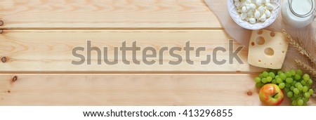 website banner of dairy products and fruits on wooden background. Symbols of jewish holiday - Shavuot