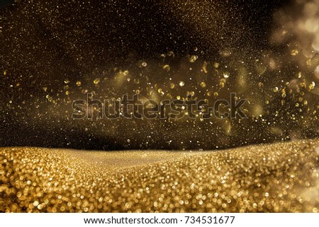 glitter vintage lights background. gold and black. de focused.