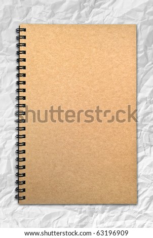 brown cover recycle paper notebook isolated on white crumpled paper background