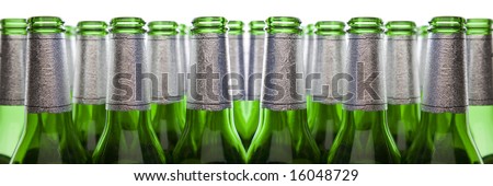 Concept of Glass Recycling - Green Glass Bottles Isolated on White
