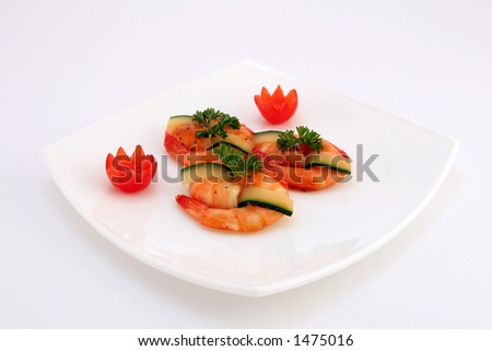 Gourmet chinese food, tiger king prawns served with a vegetable garnish, close up with copy space, isolated on white