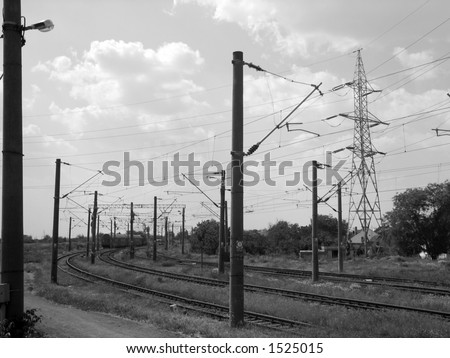 High voltage power lines over train tracks with copy space.