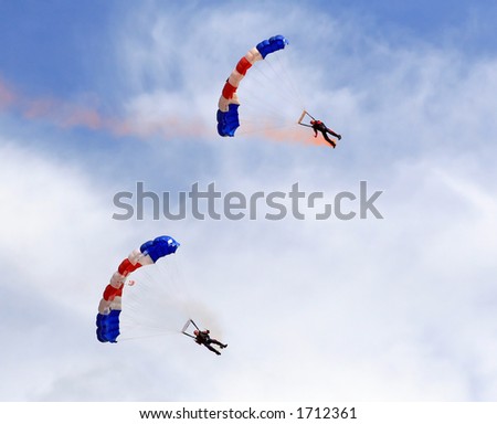 Paragliders descending in a military skydiving parachute demonstration