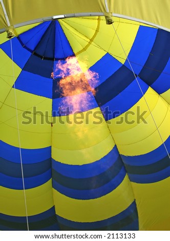Blue and yellow hot air baloon firing flame burner