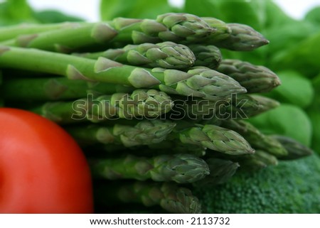 healthy groceries, asparagus, cherry tomatoes and vegetables isolated on white