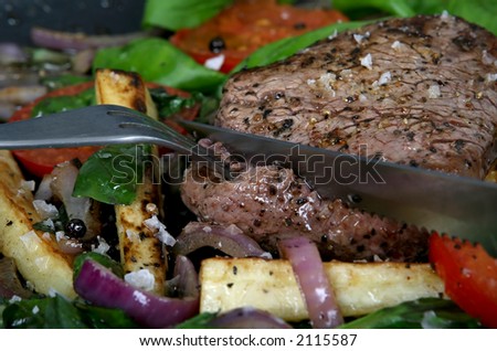 Summer lunch with spring vegetables, cherry tomato & steak, macro closeup