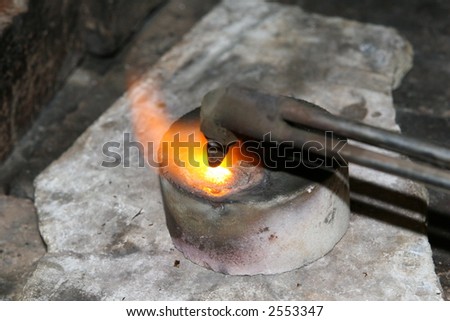 acetylene torch smelting hot precious metals, macro close up with copy space