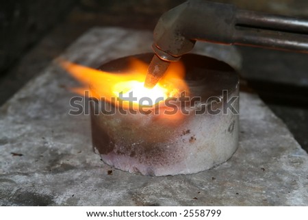 acetylene torch smelting hot precious metals, macro close up with copy space