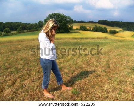Girl on cell phone, on farm