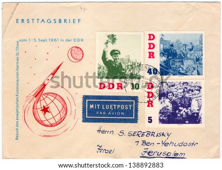 GERMANY - CIRCA 1961: An old used German Democratic Republic envelope and 3 postage stamps issued in honor of the visit of Russian Soviet cosmonaut Gherman Titov to GDR; series, circa 1961