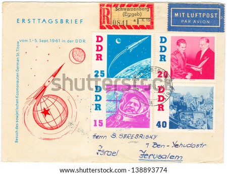 GERMANY - CIRCA 1961: An old used German Democratic Republic envelope and 4 postage stamps issued in honor of the visit of Russian Soviet cosmonaut Gherman Titov to GDR; series, circa 1961