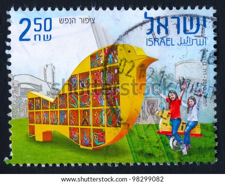 ISRAEL - CIRCA 2010: An used Israeli postage stamp showing the happy child\'s game on the playground with inscription in Hebrew, Arabic and English \
