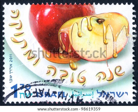 ISRAEL - CIRCA 2011:  An used Israeli Postage stamp issued in honor of the Jewish New Year (Rosh Hashanah), showing apple soaked in honey, with inscription: \