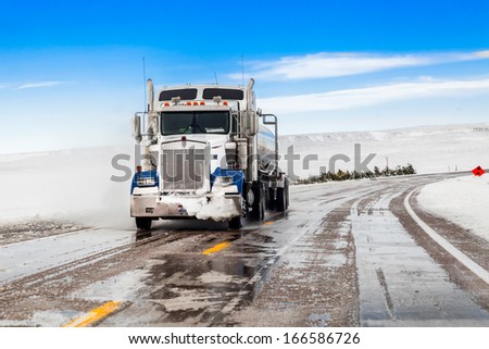 big truck drives on snow highway