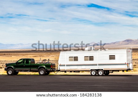 pick up truck  with RV travel trailer on the road