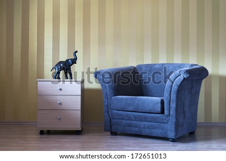 Modern Interior Room With Sofa Chair And Stripes Wall And Elephant Sculpture