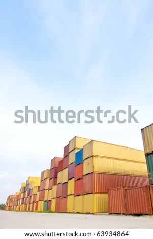in the container storage area, we can see too much lifting truck and colorful stack under the blue sky