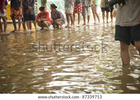 AYUTTAYA, THAILAND - OCT 15: Unidentified flood victims wait for food and beg for assistance after a monsoon flooded their home on October 15, 2011 in Ayuttaya, Thailand.
