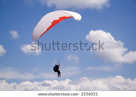 Paraglider landing on a cloud.  In fact he was taking part in a cross country race.