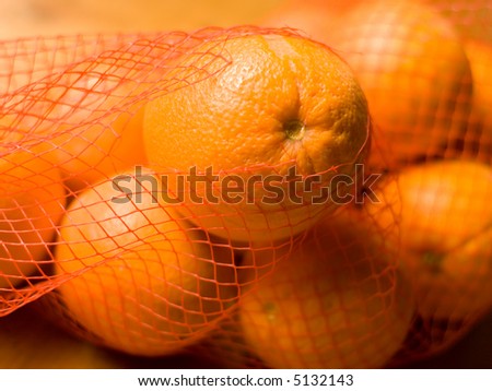 Orange ready to be taken from a bag - landscape format