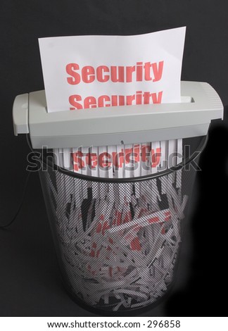 shredder over mesh waste bin with security message being shredded.