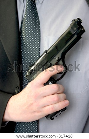 right hand holding gun against chest